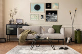 Modern living room with a gray sofa, coffee table, and decorative wall art.
