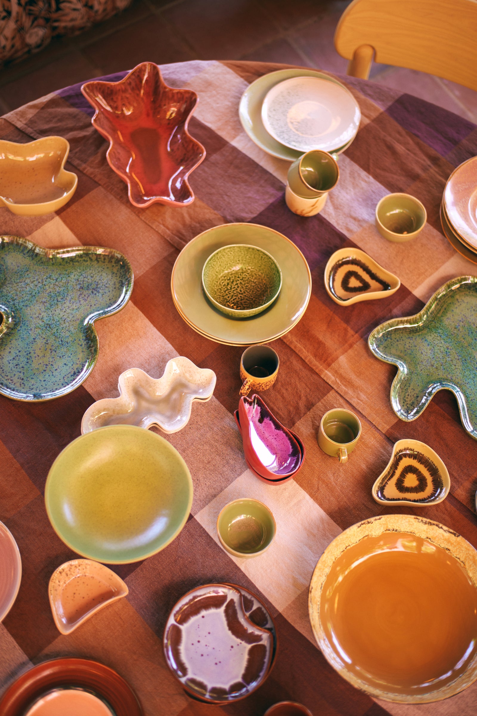 Collection of colorful ceramic dishes on a wooden surface