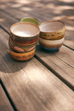 Stacked ceramic bowls on a wooden surface