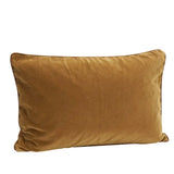 A rectangular velvet throw pillow in a warm camel brown color, shown against a plain white background.