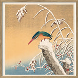 A framed Japanese-style art print depicting a colorful bird perched on a snow-covered branch, with a warm beige background and blue water at the bottom.
