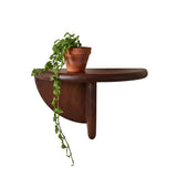 Wooden shelf with a glass vase on a beige wall