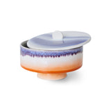 Decorative ceramic container with a gradient design on a white background