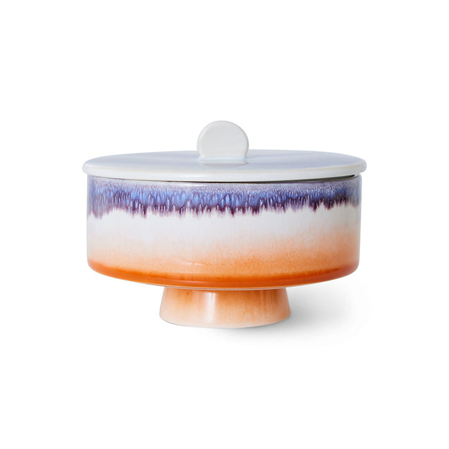 Ceramic cake stand with gradient color design on a white background