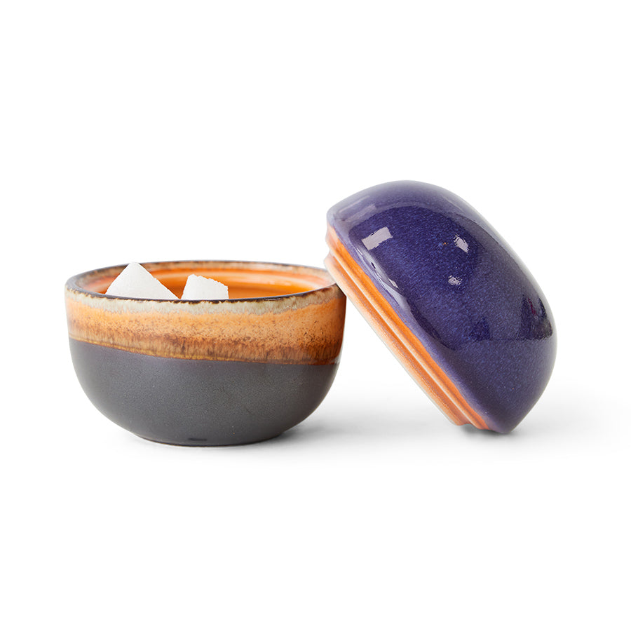 Ceramic bowl with a purple lid on a white background