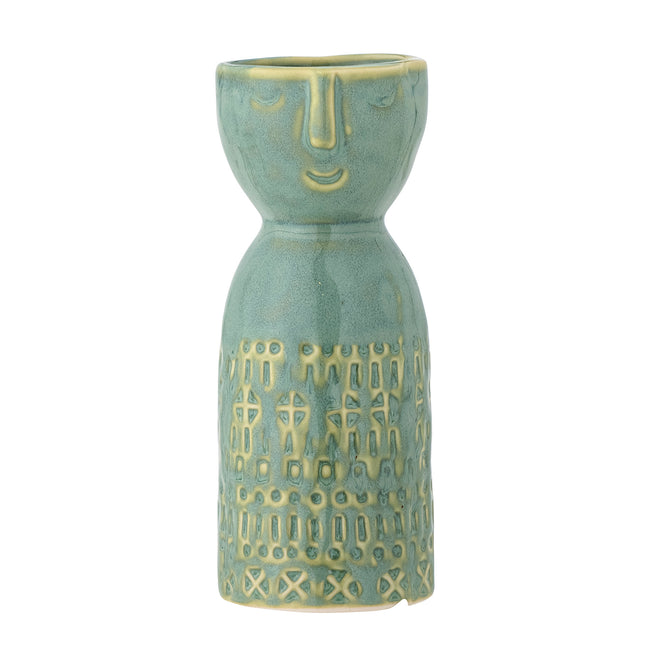 Ceramic vase with face design on a white background