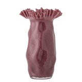 A glossy, textured ceramic vase in a dusty rose or mauve color, featuring a flared, ruffled rim and an organic, wavy silhouette, set against a plain white background.