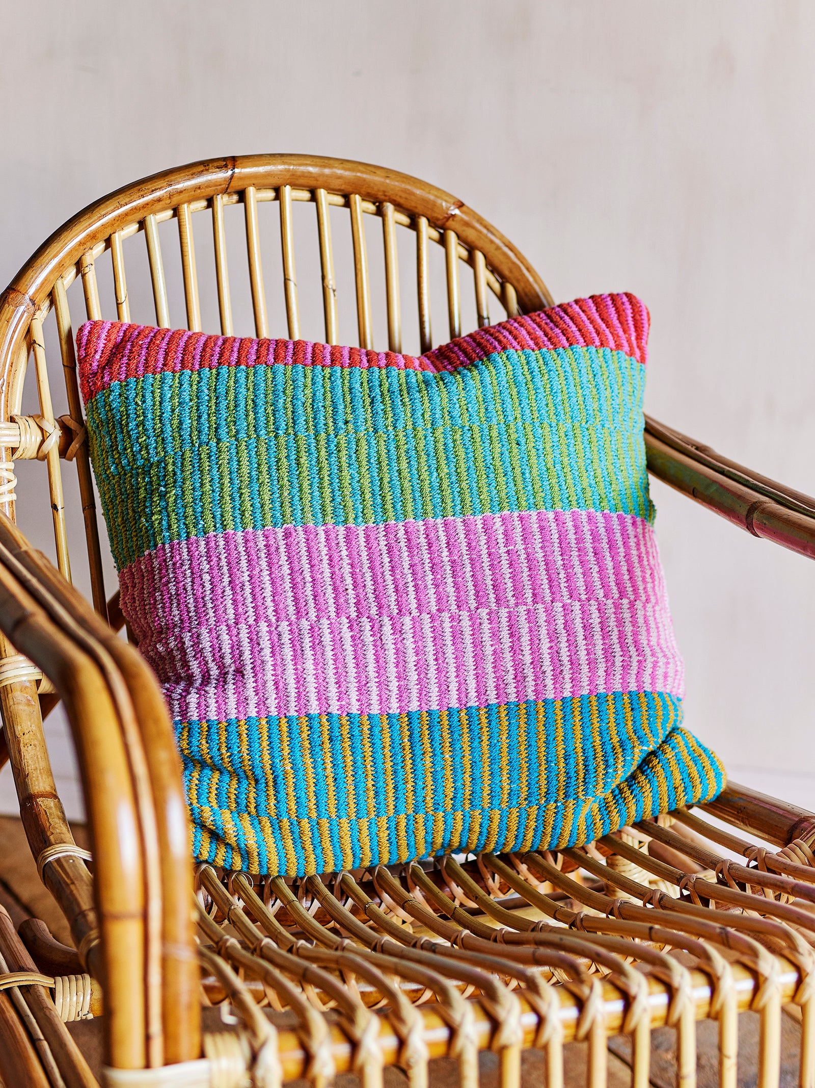 colorful stripe cushion on rattan chair