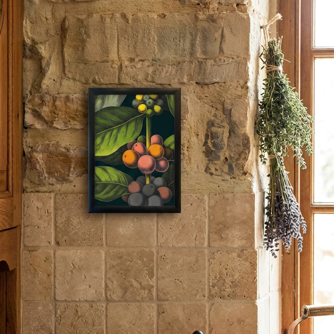 A framed botanical art print depicting green leaves and colorful cherries hangs on a rustic stone wall above a wooden counter with coffee beans, a mortar and pestle, and a French press in a warm kitchen setting.
