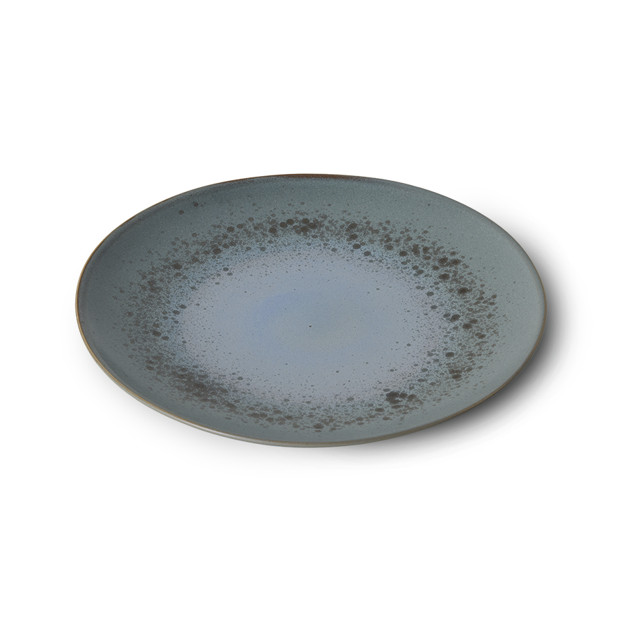 Round ceramic plate with a speckled design on a white background