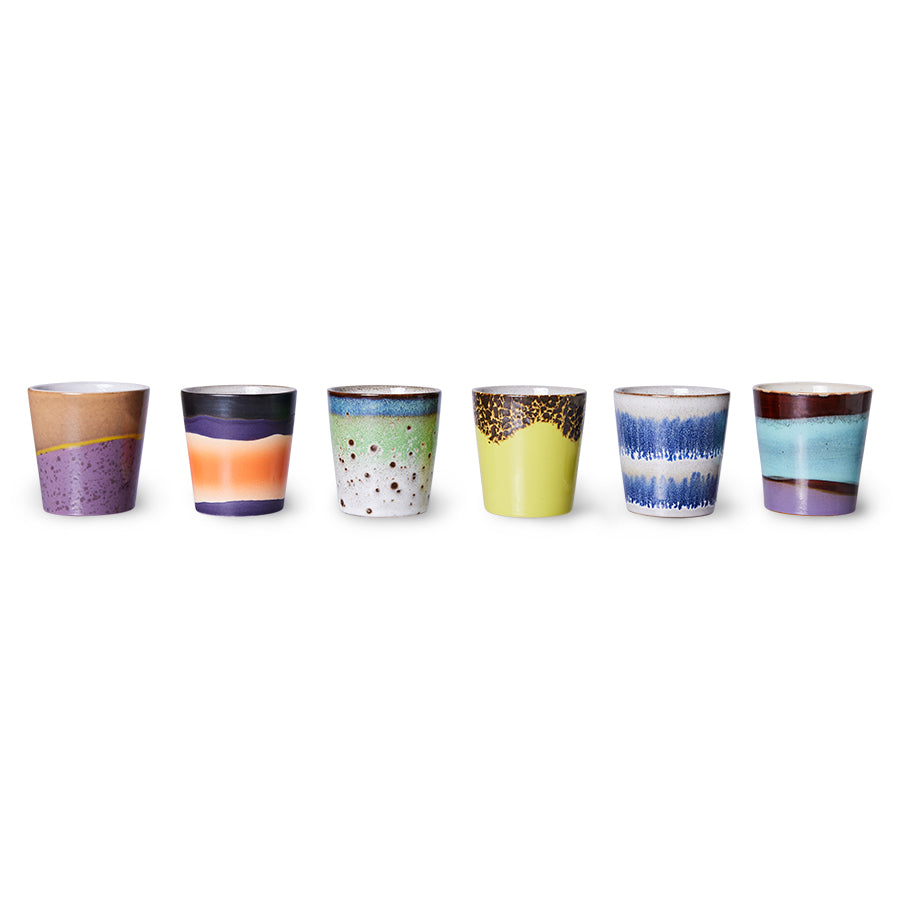 Set of six colorful ceramic cups with gradient designs on a white background