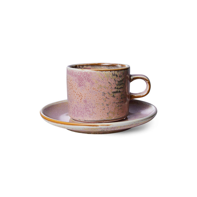 Ceramic cup and saucer with a speckled design on a white background
