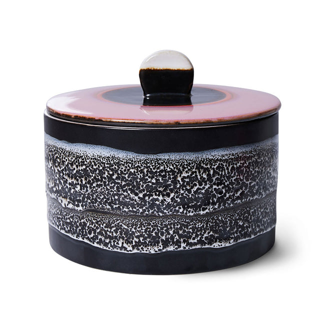 Ceramic container with a speckled design on a white background