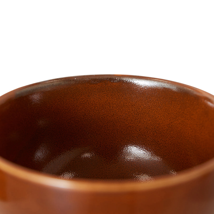 Close-up of a brown ceramic bowl on a white background