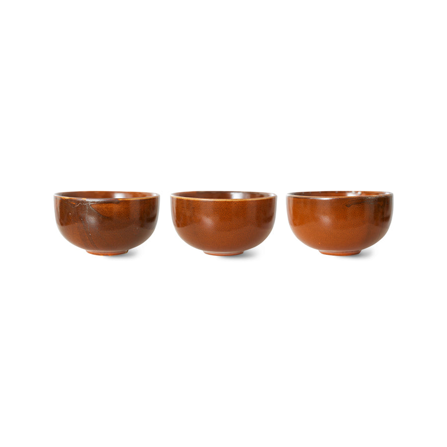 Three brown ceramic bowls on a white background