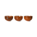Three brown ceramic bowls on a white background