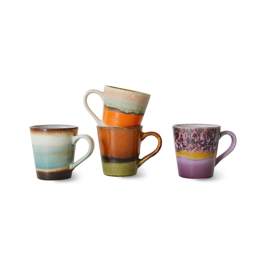 Set of four ceramic mugs with multicolored glaze on a white background