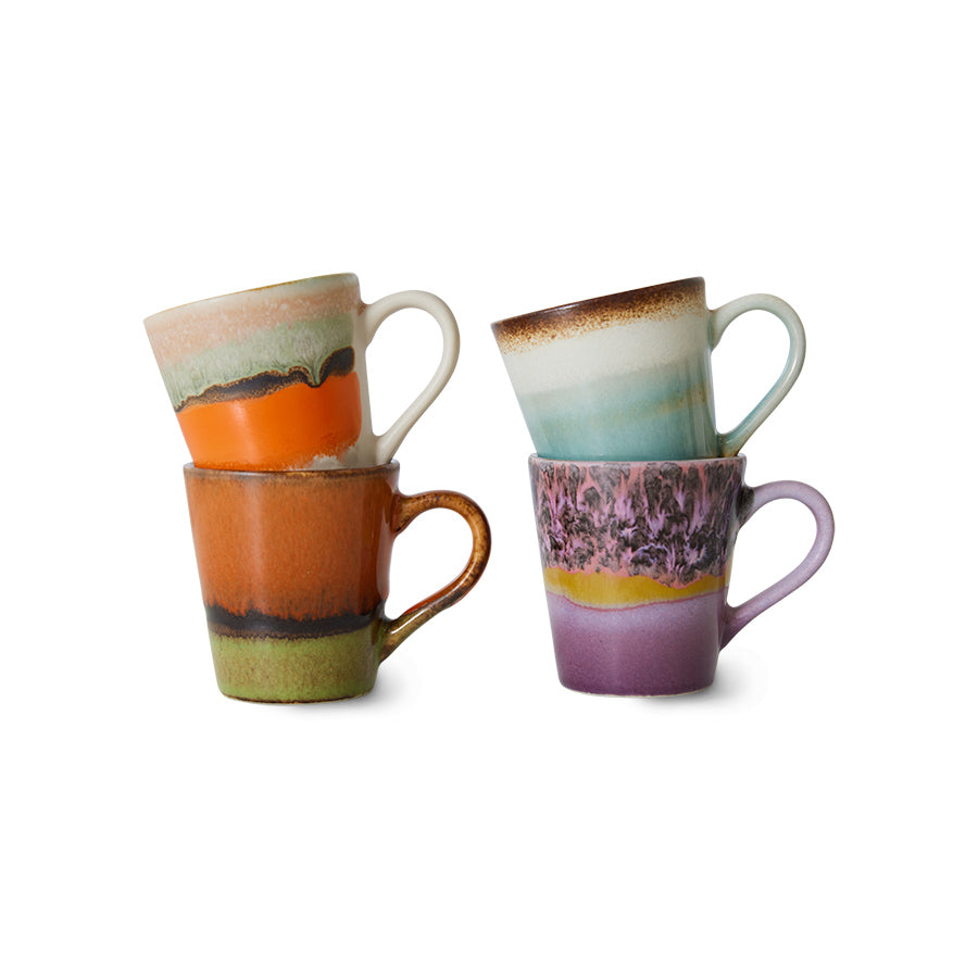 Set of four ceramic mugs with multicolored glaze on a white background