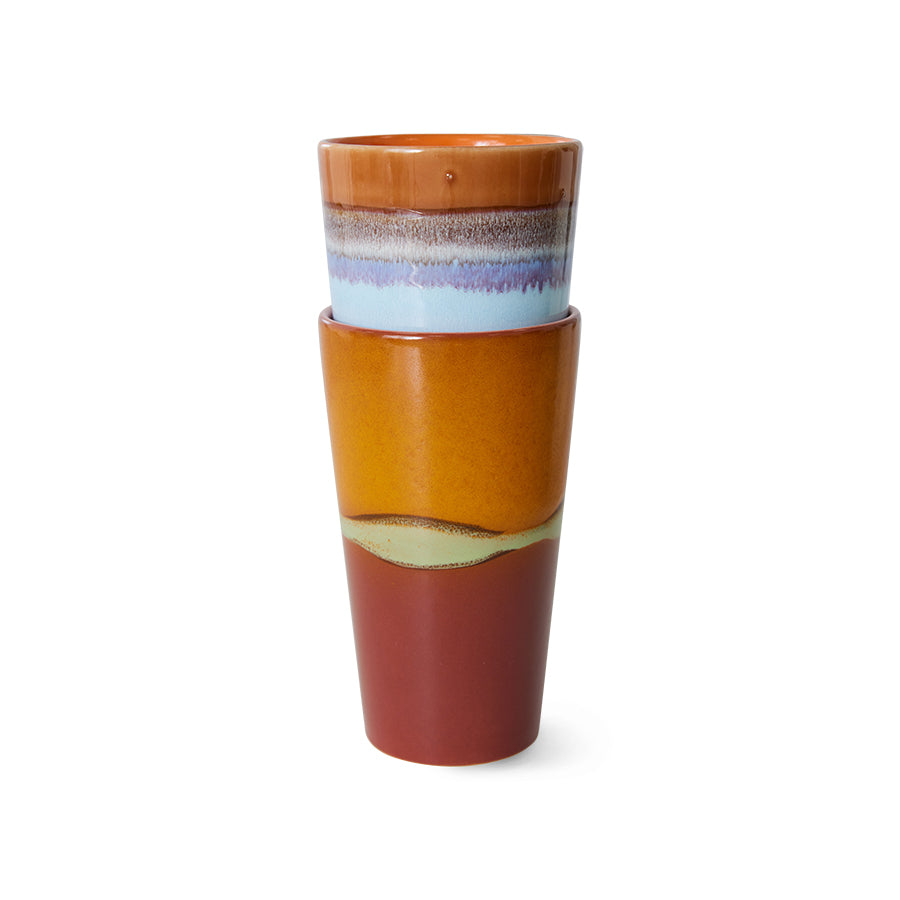 Stack of ceramic cups with multicolored glaze on a white background