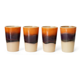 Four ceramic tumblers with a gradient color pattern on a white background