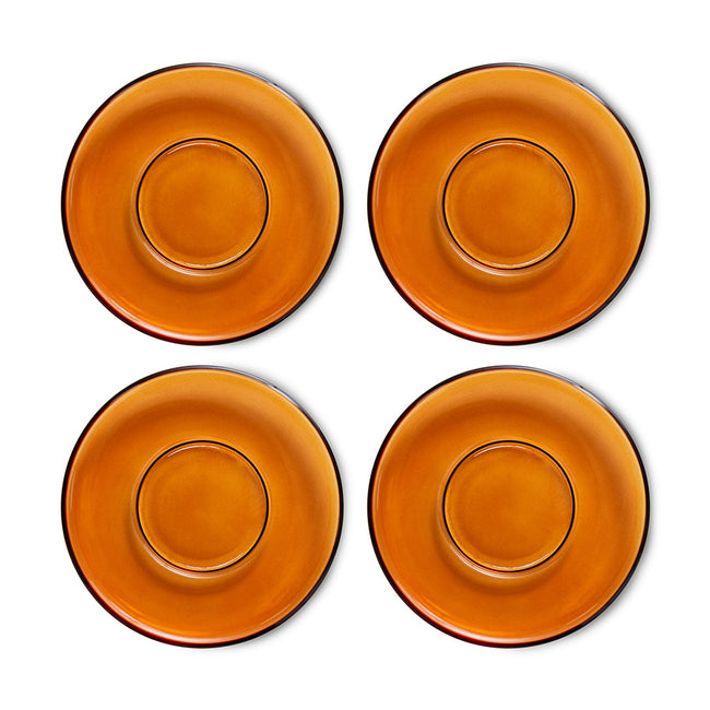 Four orange ceramic plates on a white background