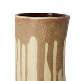 Close-up of a ceramic vase with a brown and cream drip glaze pattern on a white background.