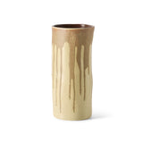 A handmade ceramic cylinder vase with a dripping glaze design, featuring a warm brown top section and a cream-colored lower body with brown drips, set against a plain white background.