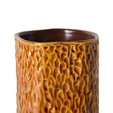 A close-up of a cylindrical ceramic vase with a textured, organic bark-like glaze in warm brown and amber tones, set against a plain white background.