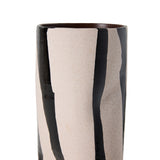 A close-up of a cylindrical ceramic vase with a speckled cream-beige glaze and bold glossy black vertical streaks, shown against a plain white background.