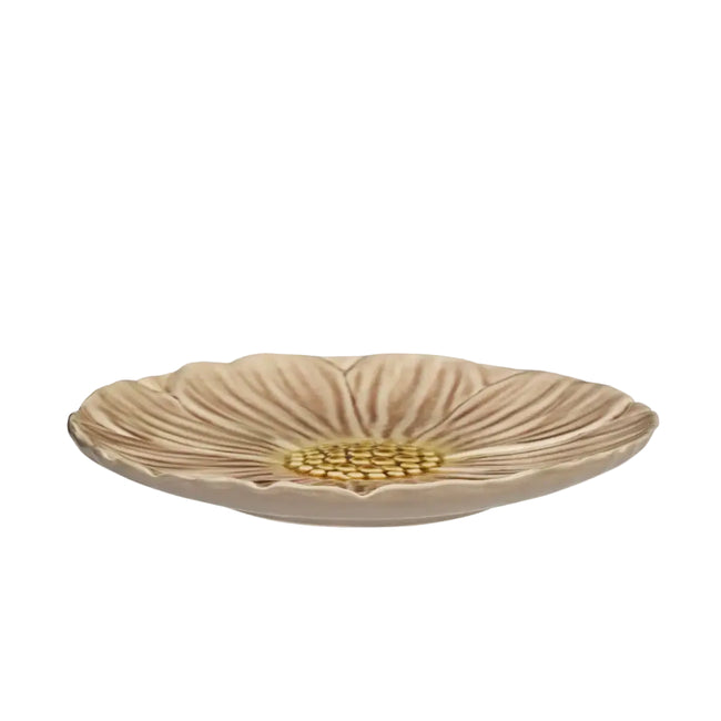 A shallow round ceramic dish shaped like a flower, featuring textured beige petals and a gold-colored center, shown against a plain white background.