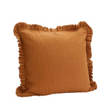 Brown textured pillow with ruffled edges on a white background