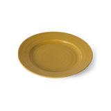 A round ceramic plate in a warm mustard yellow color, shown from a top-down perspective on a clean white background.