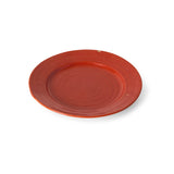 A round terracotta red ceramic plate with a subtle concentric ring design in the center, shown on a plain white background with a soft drop shadow.