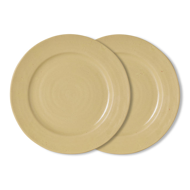 Two round ceramic plates in a light sandy beige color, overlapping on a clean white background.