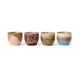 Set of four ceramic cups with gradient glaze on a white background