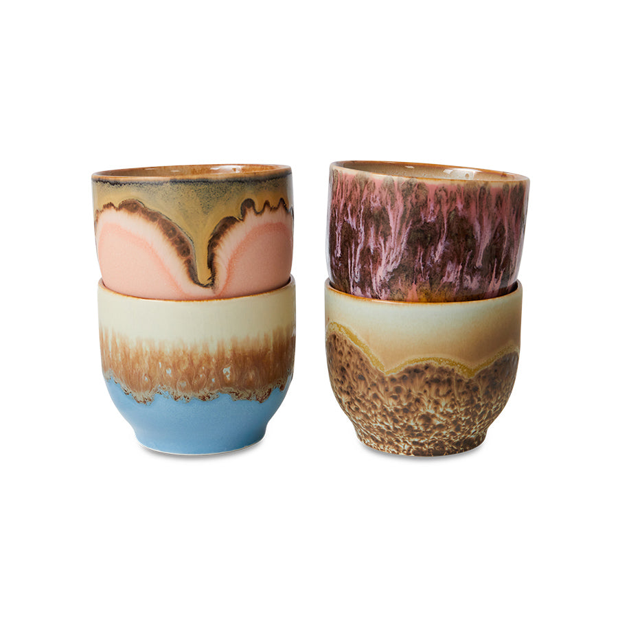Two ceramic tumblers with multicolored glaze on a white background