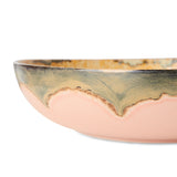 Ceramic bowl with a gradient from gold to pink on a white background