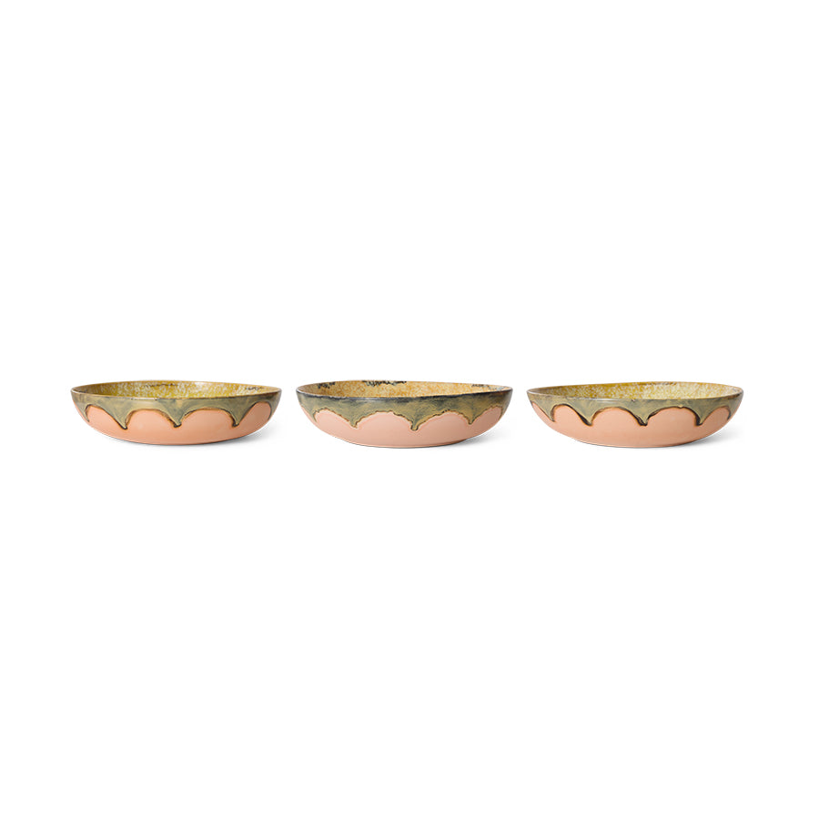 Three small decorative bowls with scalloped edges on a white background