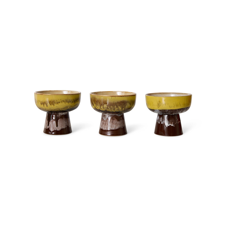 Three ceramic bowls with a green and brown glaze on a white background