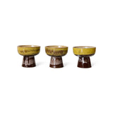 Three ceramic bowls with a green and brown glaze on a white background