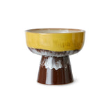 Ceramic bowl with yellow top and brown base on a white background