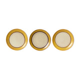 Three round plates with gold rims on a white background