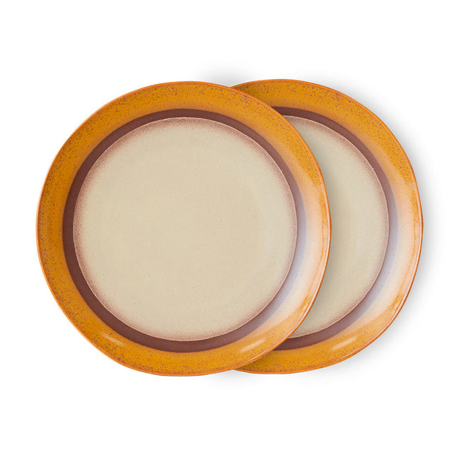 Two round ceramic plates with a brown rim on a white background