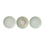 Three round ceramic plates with a subtle gradient of green and white on a white background