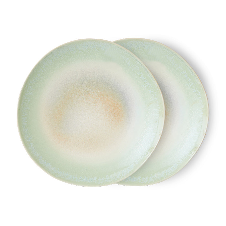 Two light green ceramic plates on a white background