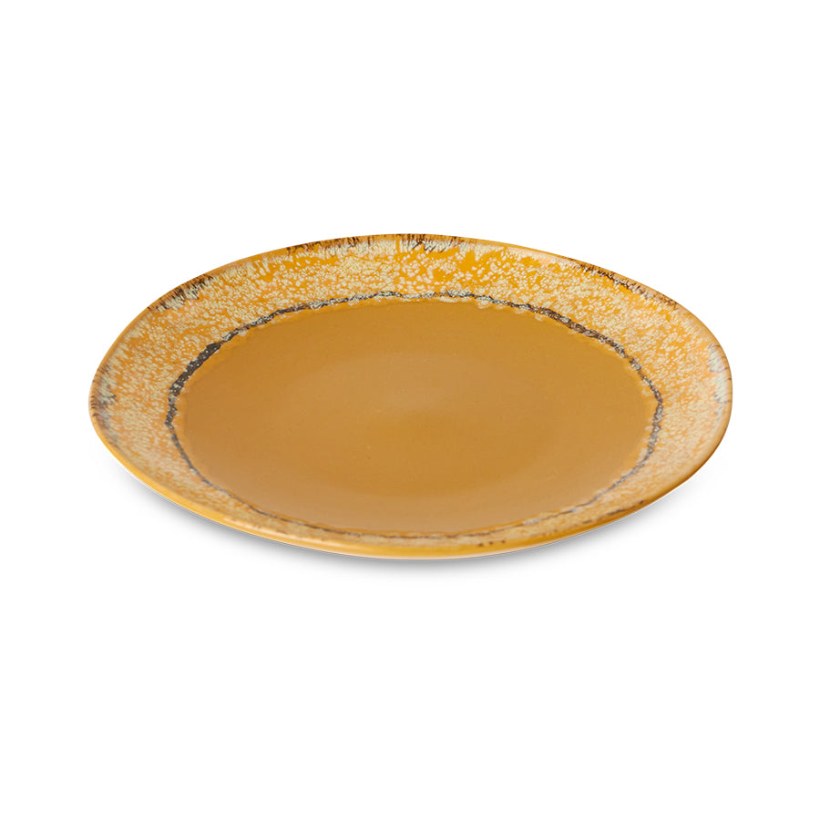 Round ceramic plate with a textured edge on a white background