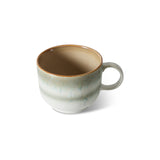 Ceramic mug with a gradient color from brown to beige on a white background