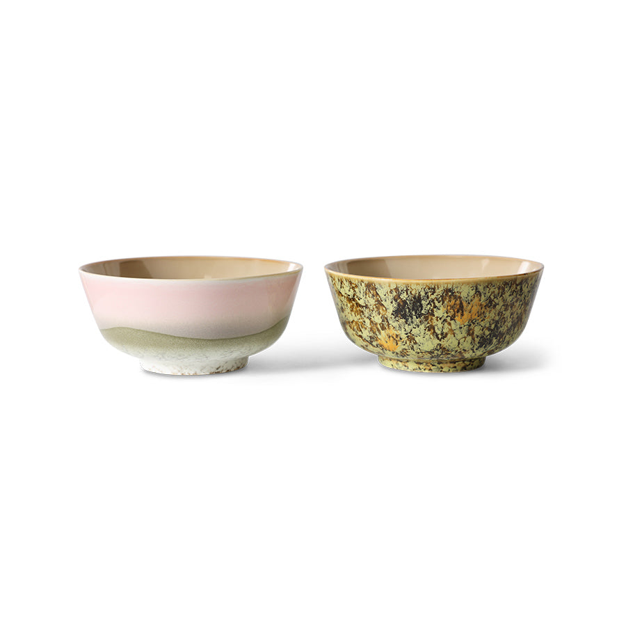 Two ceramic bowls, one with a pink interior and yellow exterior, the other with a greenish-brown exterior, on a white background.