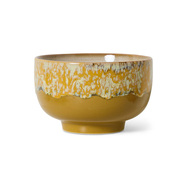 Yellow ceramic bowl with textured surface on a white background