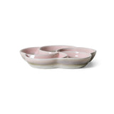 Pink ceramic dish with three compartments on a white background